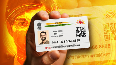 An Indian State ID card being held up.