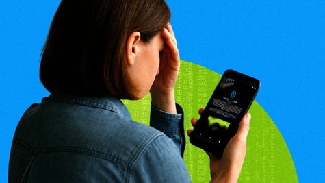 A disconcerted parent worrying as a data breach happens on her phone.