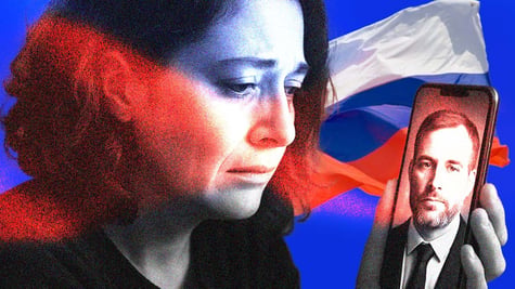 A Russian widow gazing at her deceased soldier husband, with the Russian flag in the background.