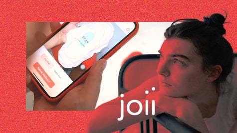 A woman looking at Joii period app on her phone