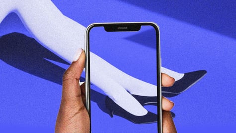 A phone taking a photo of elegant legs.