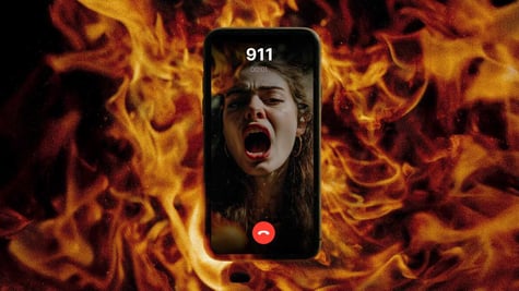 A terrified victim on the phone screen in the blaze of a fire.