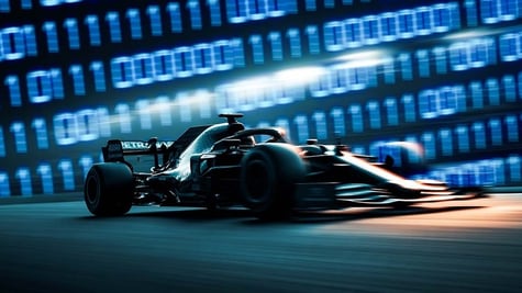 Black formula 1 car speed driving, baby blue blurry number wall behind it