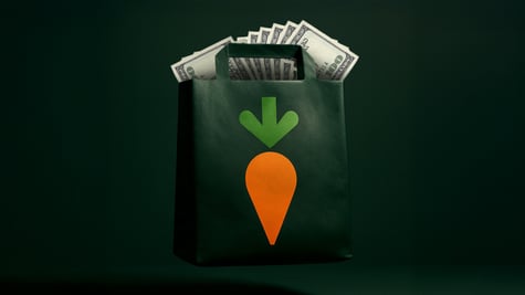 A black bag full of money with an image of a carrot on it