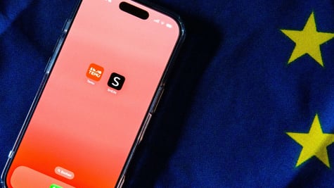 Temu and Shein apps on an iPhone screen with EU flag in the background