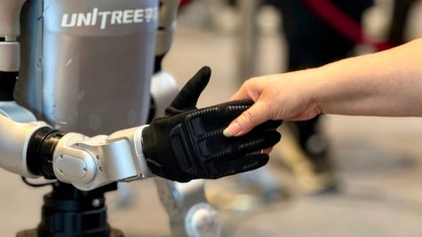 Unitree humanoid robot shaking hands with a human