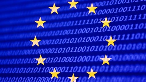 The EU flag placed on a screen full of code.