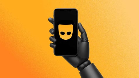 A robot's hand holding a smarphone with Grind's logo on the screen