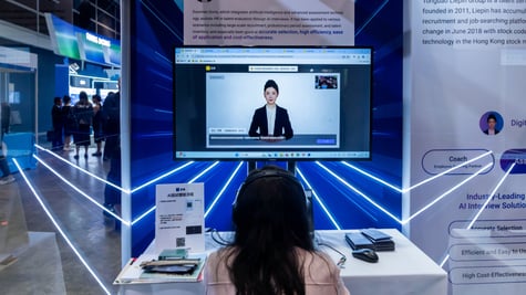 woman, black hair, screen, talks to AI asian assistant in suit. baby blue lasers, well lit room