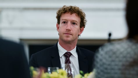 Mark Zuckerberg at dinner table, black tie, pale skin, white shirt, black eyes, curly hair