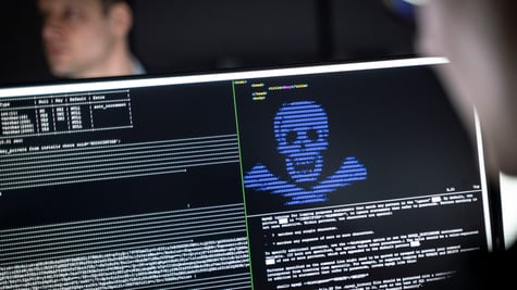 blurry man face in left top corner, black screen, white and blue letters, human scull