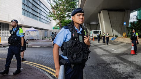 hong kong police officer, black bulletproof west, young asian man, blue short sleeve shirt