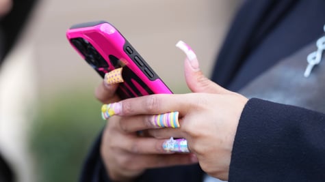 phone user with long nails