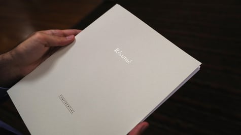 Resume with tag "confidential" in person's hands; CV; fake resumes; HR