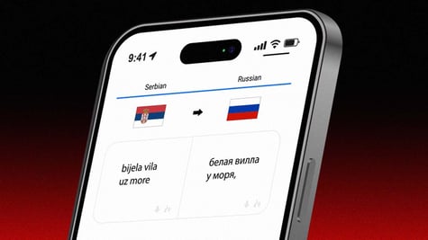 Screen with Google Translate window, phrase "white villa by the sea" in Russian and Serbo-Croatian