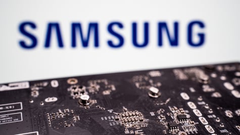 black microchip with metalic details, samsung blue logo in blurry white background