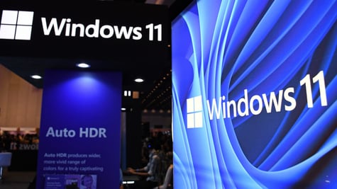 windows 11 logo on top left corner in black and white, and on right in blue and white