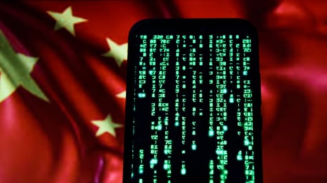 matrix green code on black smartphone screen, red china flag in the background, yellow star