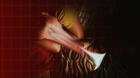 a teenage kid lies on left side in bed, face sucked in to his glowing smartphone screen.