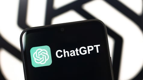 The ChatGPT logo is seen displayed on a smartphone screen.