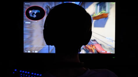 A counterstrike gamer playing in the dark.