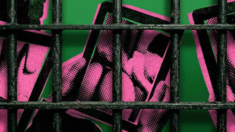 Cell bars and hands holding a tablet with erotic content
