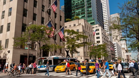 fifth avenue, sunny day, blue sky, tall buildings, pedestrians crossing street, yellow taxis,