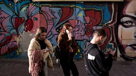 teenagers on phones, blue graffitti, 
