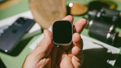 Man's hand holding Apple Watch Ultra body