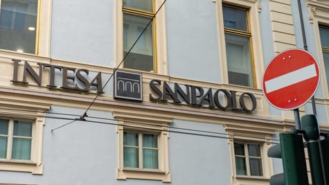 intensa sanpaolo sing over green windows, wall exterior, red stop sign