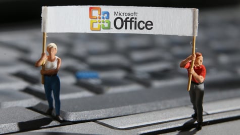 female and male mini figurines, grey keyboard, microsoft office banner, white vest, blonde hair