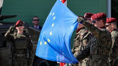 polish army men, war uniform, bordo hats, blue eu flag with yellow stars 