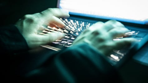 Hands on a keyboard typing.
