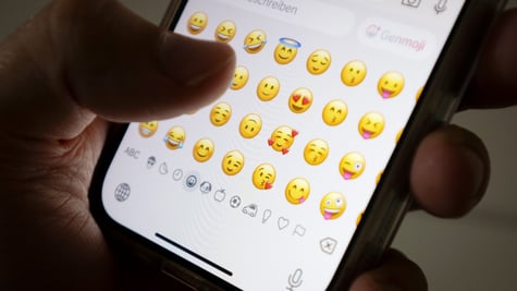 Person using emojis on the phone