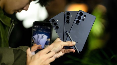 three black samsung galaxy  26S Ultra smartphones held in one hand, black pen, 