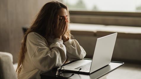 young woman using infected computer