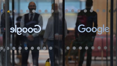 Google office in london, walkout, glass door, Google sign, two shadowy people behind glass