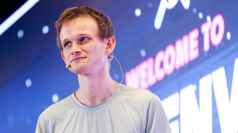 Vitalik Buterin, young pale white man, light brown gingerish hair, grey t-shirt, welcome to sign
