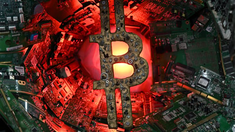 bitcoin logo made from spare metal parts or scrap metal, red light, green micro chips