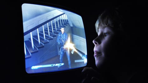 young blonde white boy, blue screen, shooter, yellow laser beam, staircase, old tv screen