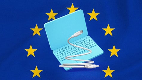 A laptop with a USB-C charger, European Union flag on the background