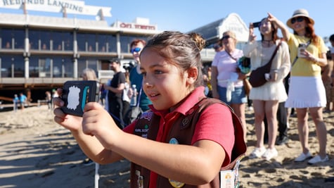 chubby girl scout, eight year old, dark pink t-shirt, vest, badges, beach, camera, people, sunny