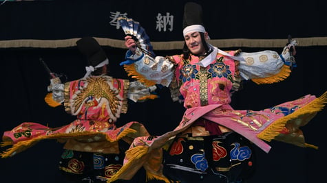 men in traditional japanese kimonos dance on stage, white sleeves, white head tie