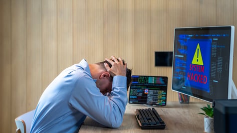 man, office, head in hands, blur computer screen