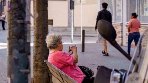 Older woman outside using a smartphone