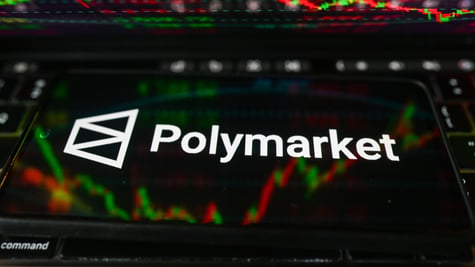 polymarket logo, white letters on black smartphone screen, market percentage charts in the back