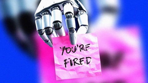 A robot's hand holding a note that says "You're fired"