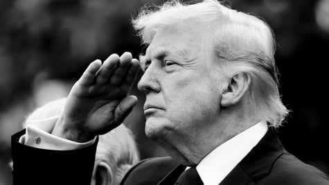 A black and white photo of President Trump saluting.