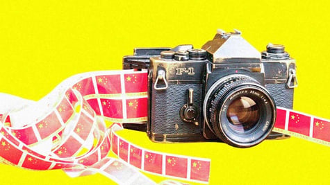 vintage looking camera spitting out tapes with china flags