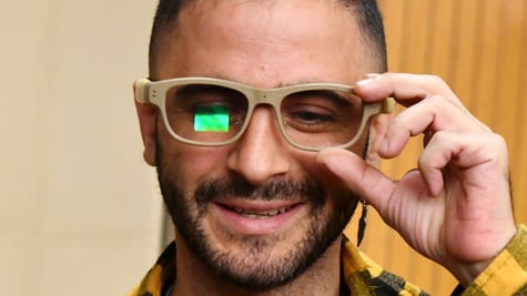 white man, mustard-color shirt, short black hair ,black beard and moustache, glasses